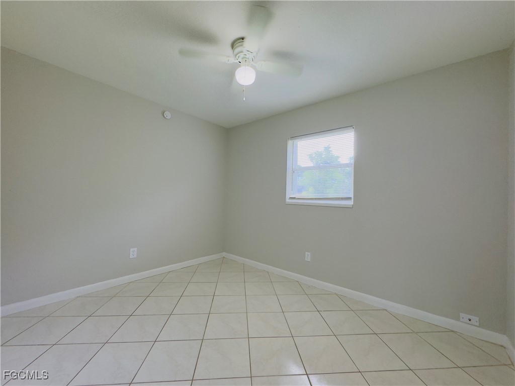 913 Hudson Avenue Lehigh Acres, FL 33936 - Photo 23 of 36 an empty room with windows and fan
