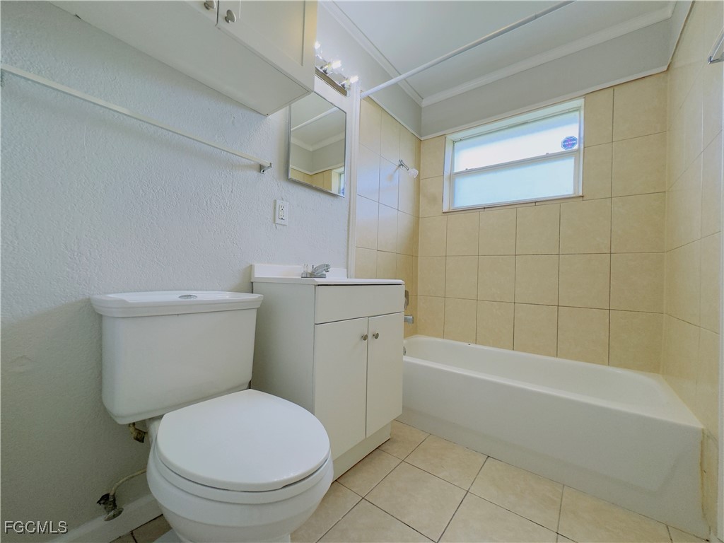 913 Hudson Avenue Lehigh Acres, FL 33936 - Photo 26 of 36 a bathroom with a toilet a sink and shower