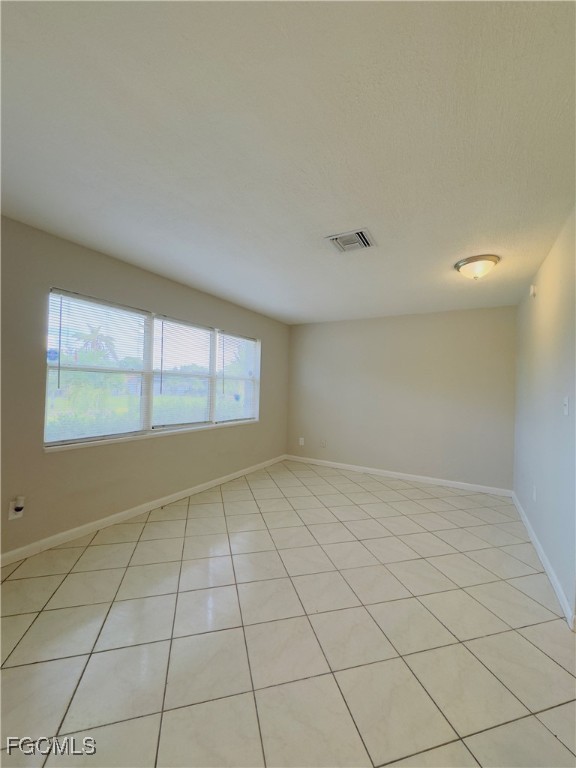 913 Hudson Avenue Lehigh Acres, FL 33936 - Photo 3 of 36 a view of an empty room and window
