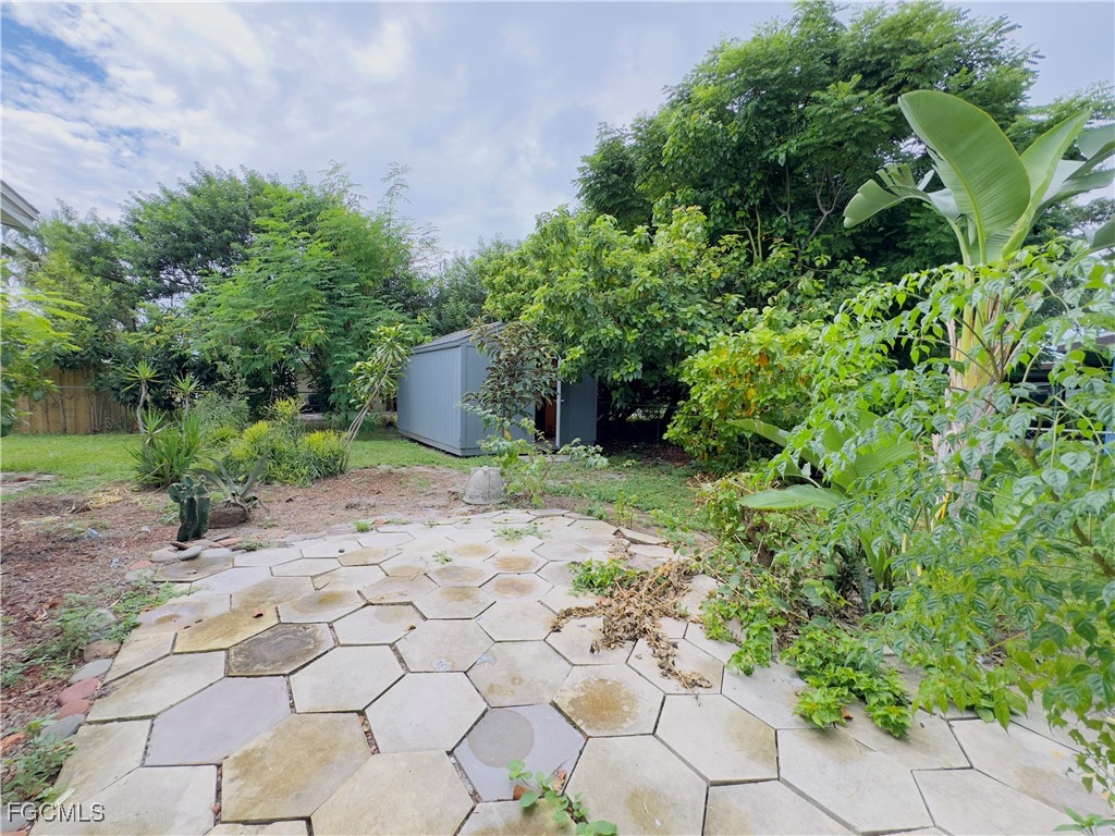 913 Hudson Avenue Lehigh Acres, FL 33936 - Photo 32 of 36 a view of a garden with large trees