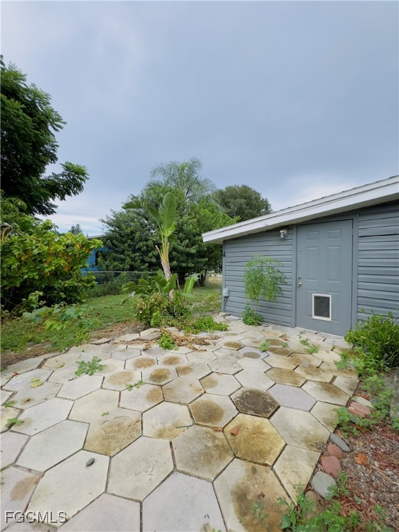 913 Hudson Avenue Lehigh Acres, FL 33936 - Photo 33 of 36 a backyard of a house with table and chairs