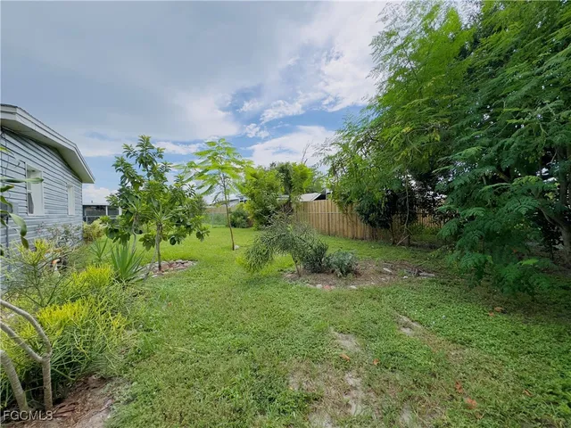 a backyard of a house with plants and entertaining space