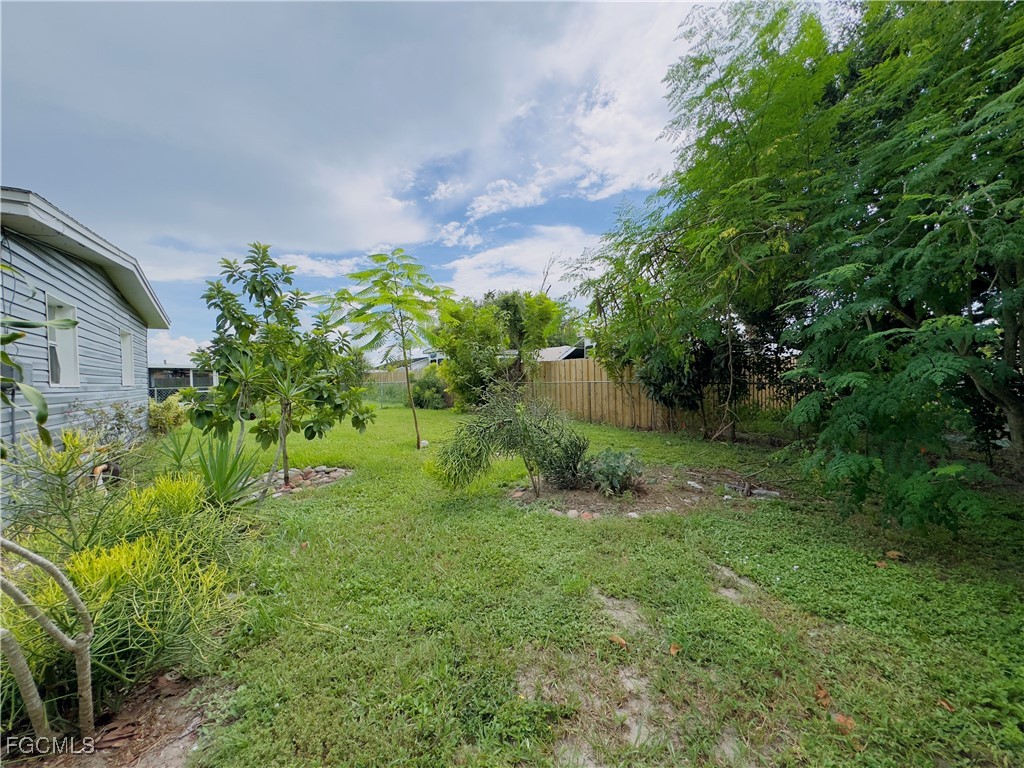 913 Hudson Avenue Lehigh Acres, FL 33936 - Photo 34 of 36 a view of a garden with a fountain