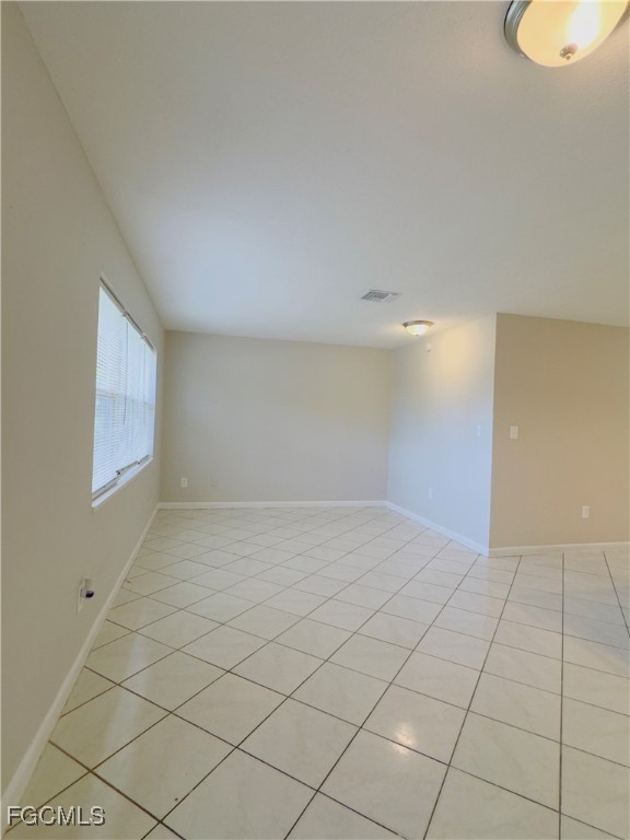 913 Hudson Avenue Lehigh Acres, FL 33936 - Photo 5 of 36 a view of an empty room and window