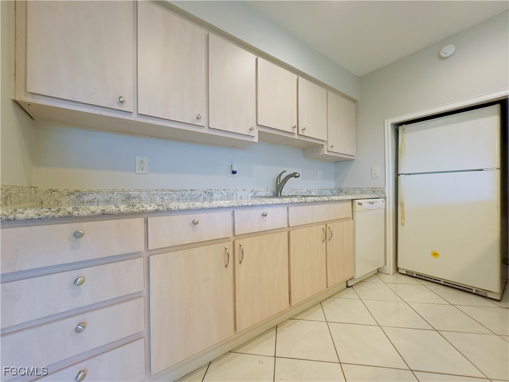913 Hudson Avenue Lehigh Acres, FL 33936 - Photo 10 of 36 a kitchen with granite countertop white cabinets and a sink