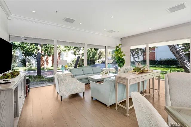 a view of swimming pool with chairs and trees