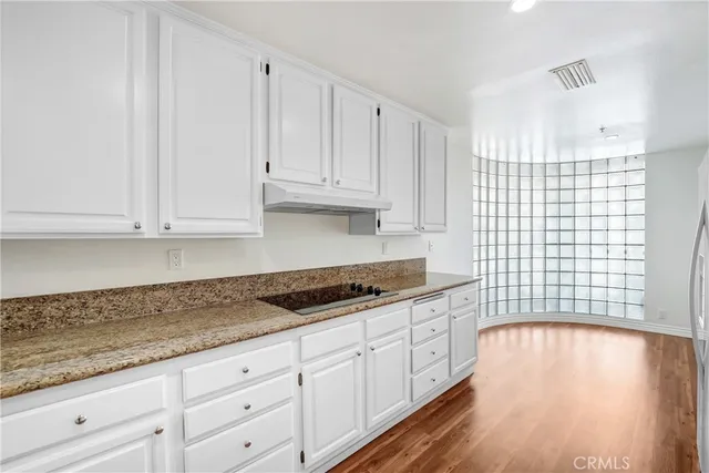 a kitchen with granite countertop white cabinets and a granite counter tops