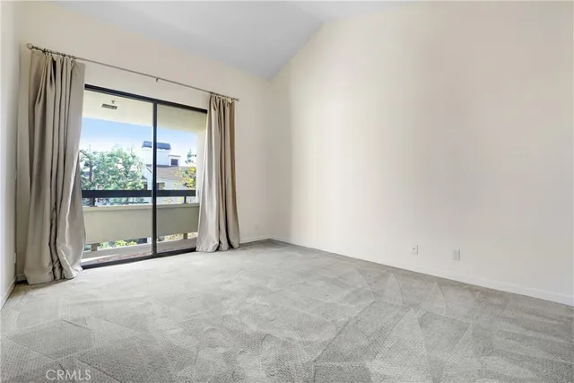 an empty room with closet and windows