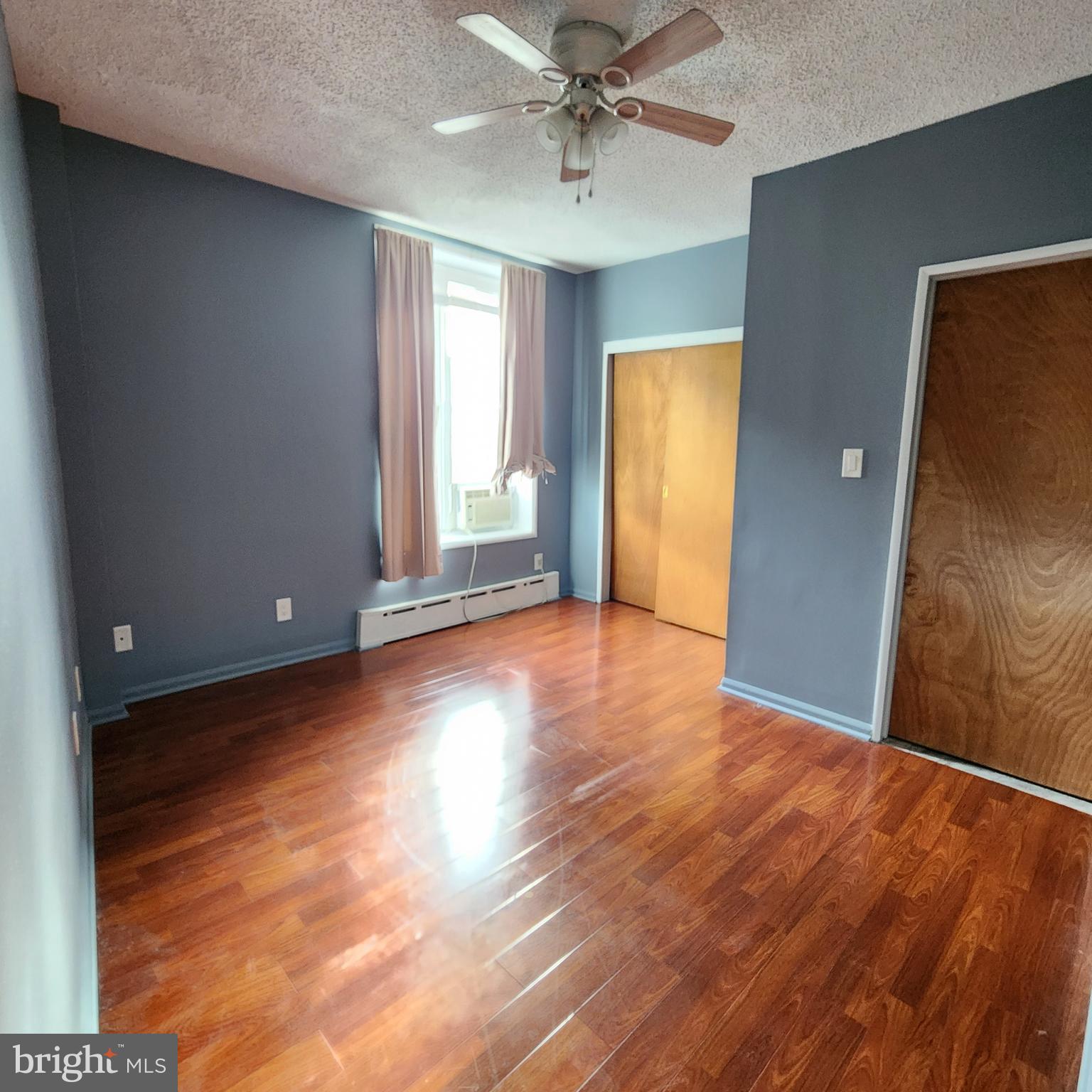 1539 East Moyamensing Avenue, Unit 1R Philadelphia, PA 19147 - Photo 6 of 7 a view of a livingroom with wooden floor and a ceiling fan
