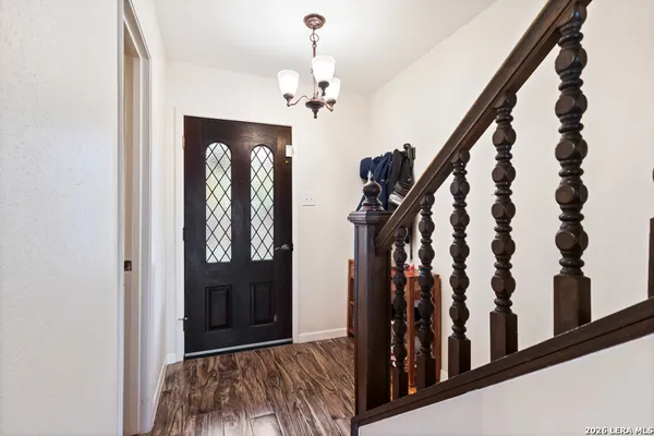 a view of entryway with wooden floor and stairs