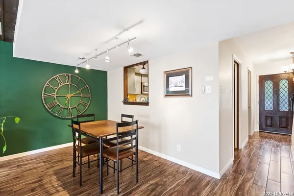 a view of a dining room with furniture and wooden floor
