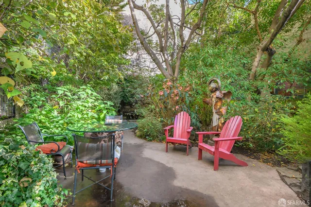 an outdoor sitting area with couch and plants