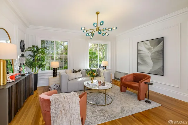a living room with furniture flowers and a chandelier
