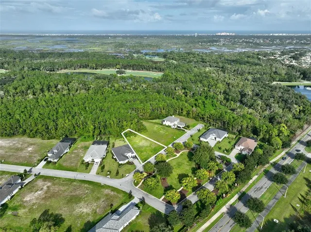 an aerial view of a house with a yard