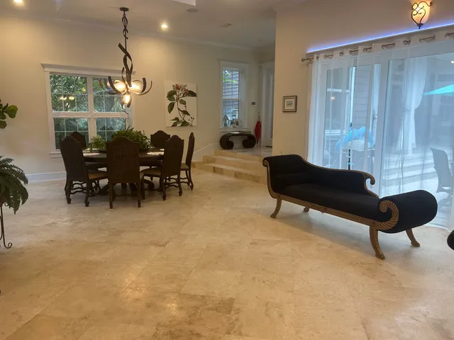 a view of a swimming pool with back yard of a house