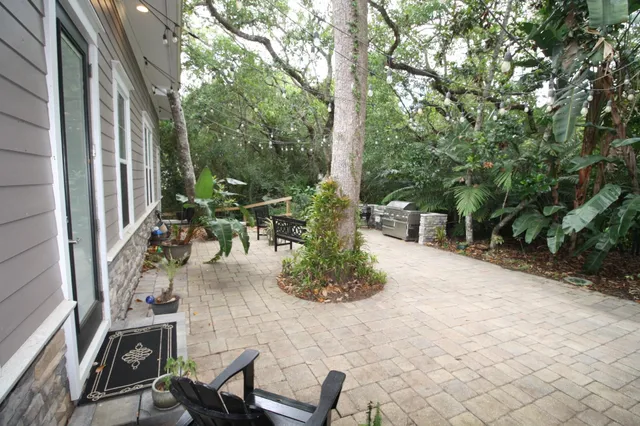 a front view of multi story residential apartment building with yard and green space