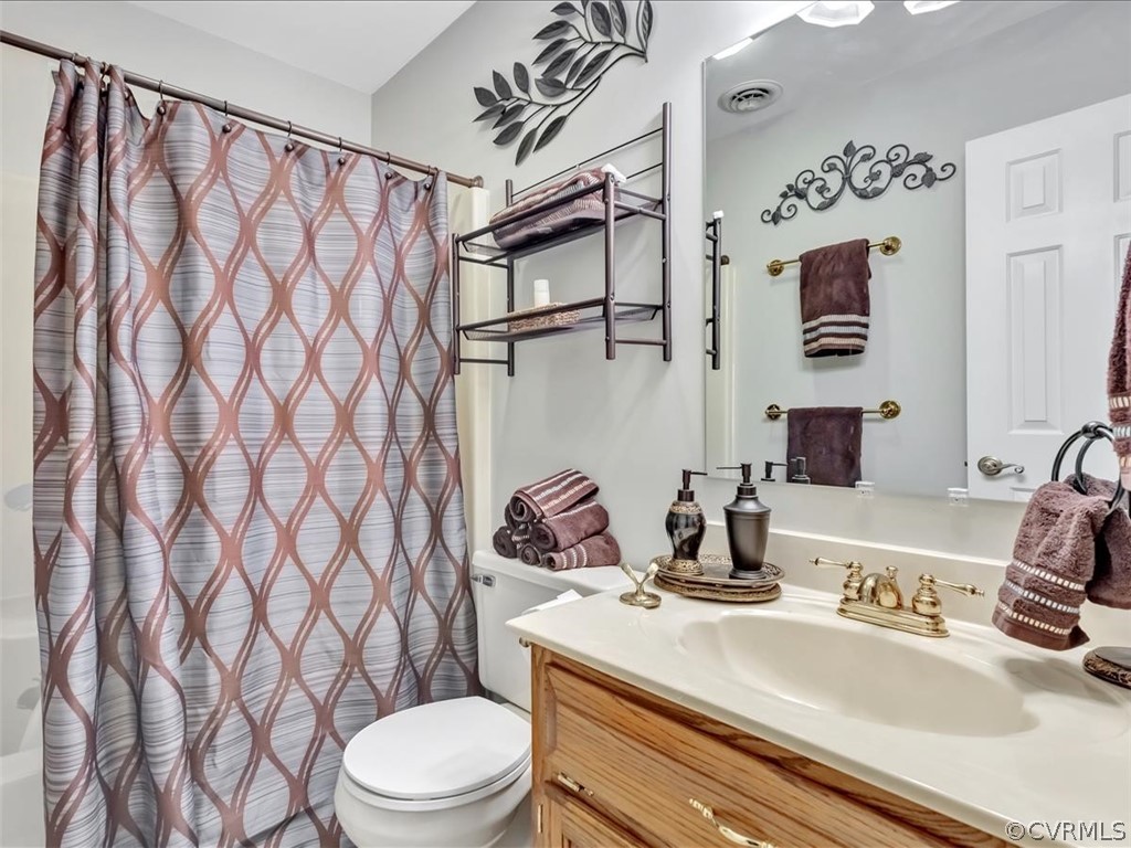 12641 2nd Branch Road Chesterfield, VA 23838 - Photo 29 of 40 a bathroom with a sink a toilet and shower curtain