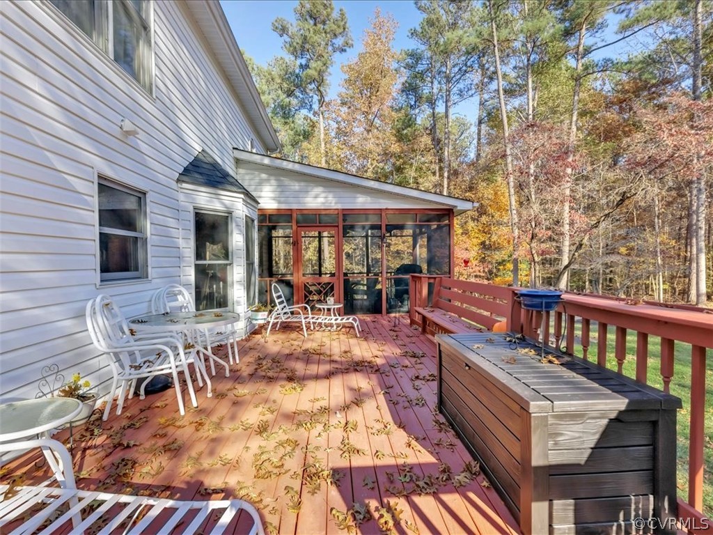 12641 2nd Branch Road Chesterfield, VA 23838 - Photo 36 of 40 a view of a patio with table and chairs with wooden floor and fence