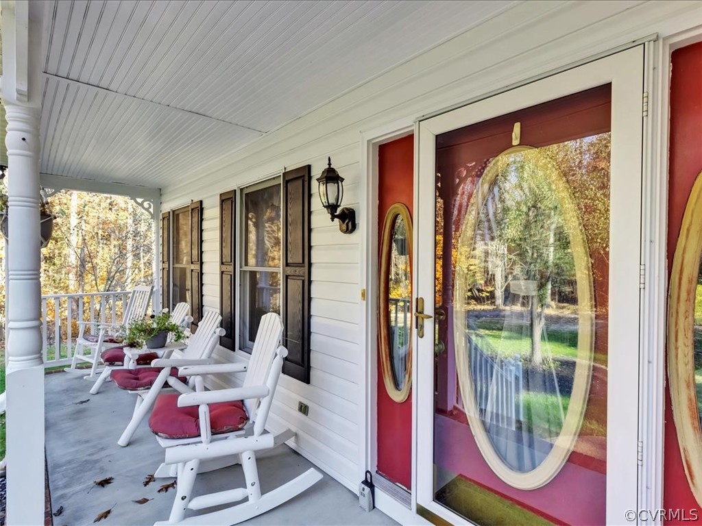 12641 2nd Branch Road Chesterfield, VA 23838 - Photo 6 of 40 a balcony with furniture and a potted plant