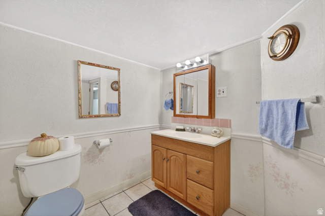 977 23rd Street Ogden, UT 84401 - Photo 22 of 29 Bathroom with a wainscoted wall, tile walls, vanity, and light tile patterned floors