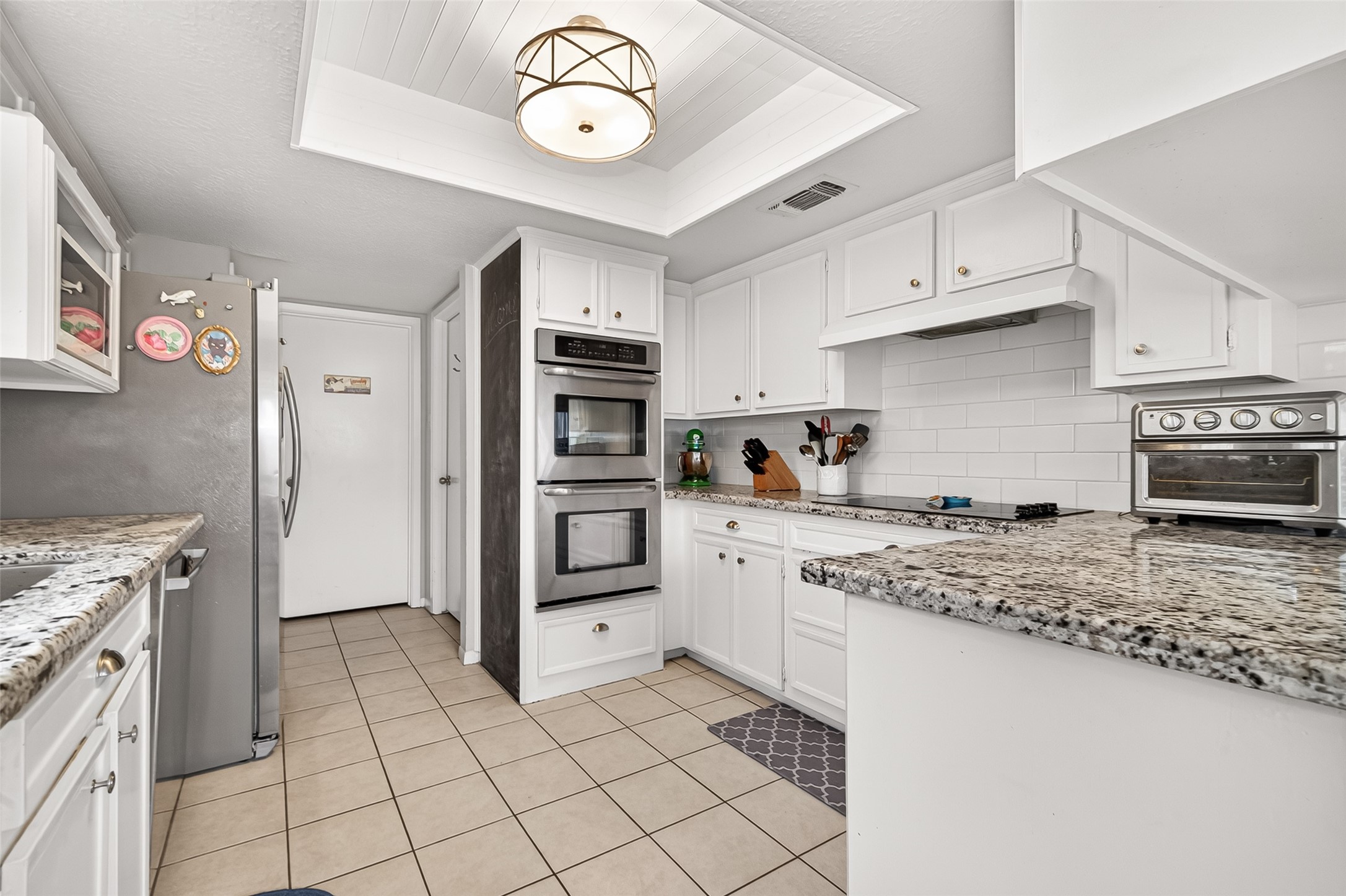 17611 Sorrell Ridge Drive Spring, TX 77388 - Photo 21 of 50 a kitchen with stainless steel appliances granite countertop a stove a sink and a refrigerator
