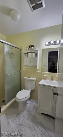 a bathroom with a sink mirror toilet and shower