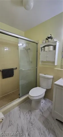 a bathroom with a toilet and a shower