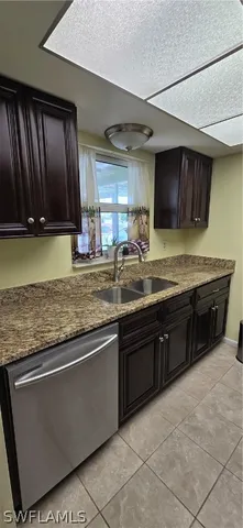a kitchen with stainless steel appliances granite countertop a sink counter space cabinets and a large window