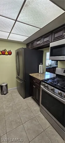 a kitchen with stainless steel appliances granite countertop a stove and a refrigerator