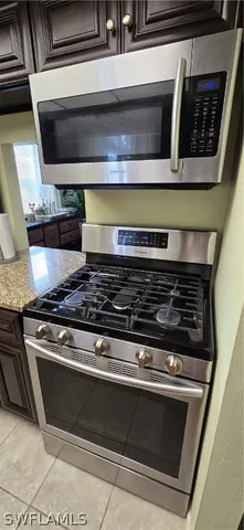 a stove top oven sitting inside of a kitchen