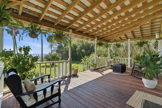a view of a swimming pool with a garden and patio