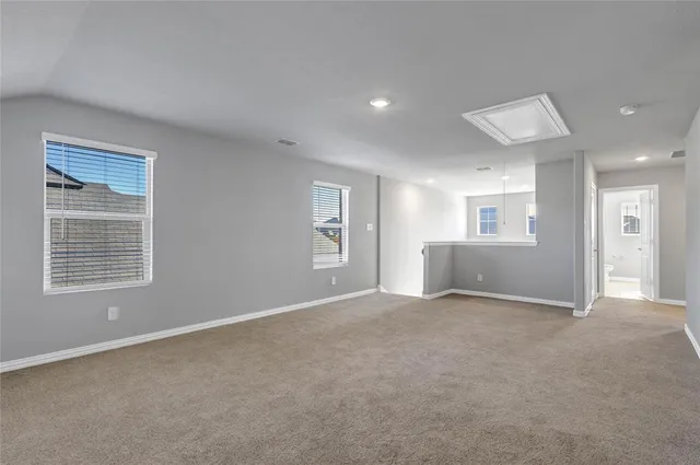 an empty room with windows and entrance