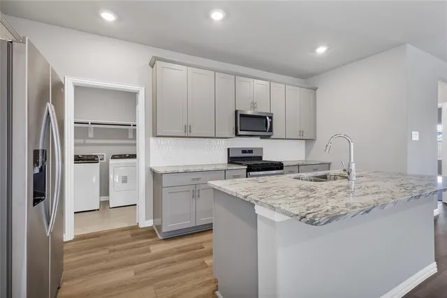 a kitchen with a sink stove and refrigerator
