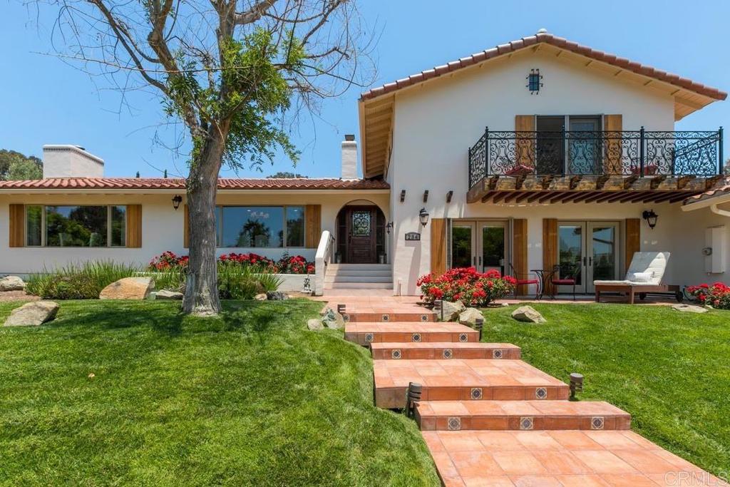 a front view of a house with a garden and porch