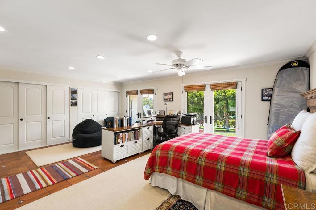 234 Winterhawk Lane Encinitas, CA 92024 - Photo 11 of 20 a bedroom with a bed a closet and large mirror