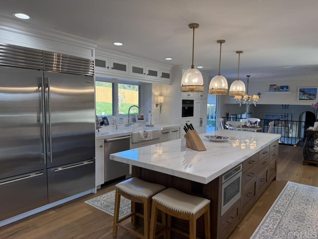 234 Winterhawk Lane Encinitas, CA 92024 - Photo 4 of 20 a kitchen with sink island and stainless steel appliances