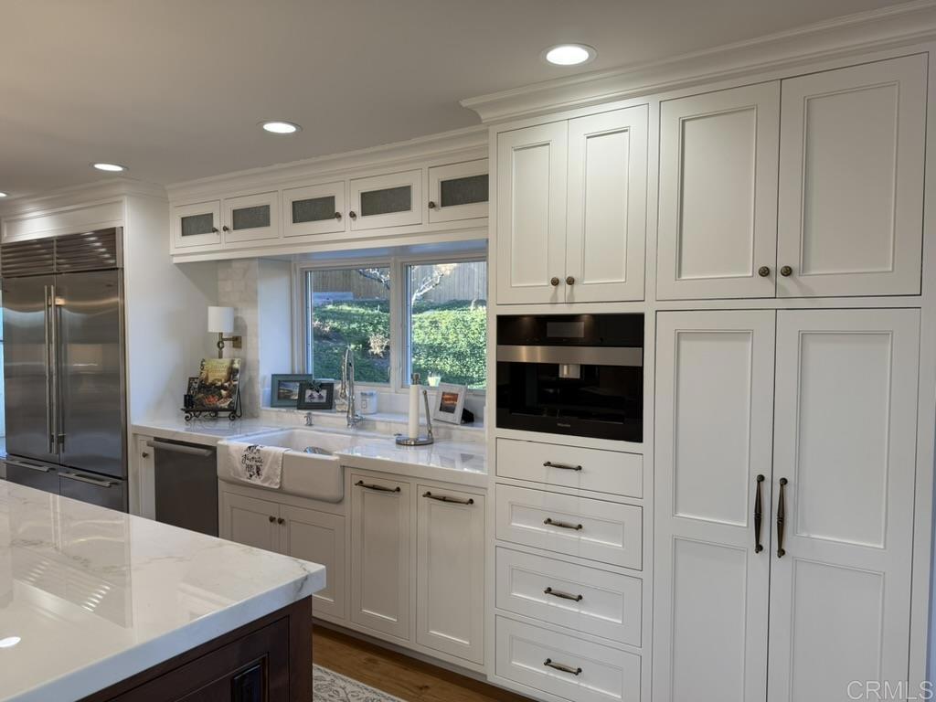 234 Winterhawk Lane Encinitas, CA 92024 - Photo 5 of 20 a kitchen with white cabinets and appliances