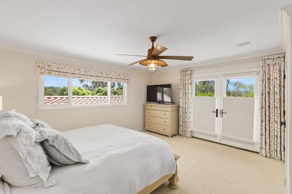 234 Winterhawk Lane Encinitas, CA 92024 - Photo 9 of 20 a bedroom with a large bed and a chandelier