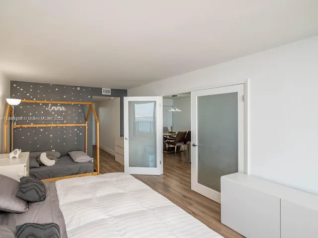 a bedroom with a bed and a large window