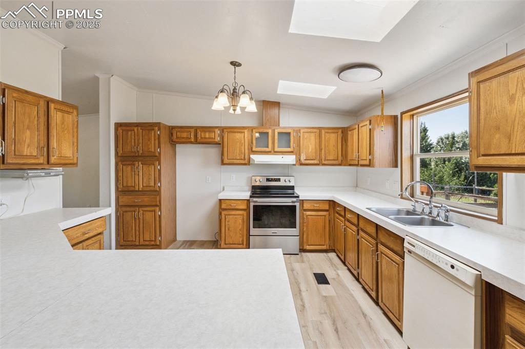 16175 Cathys Loop Peyton, CO 80831 - Photo 11 of 35 a kitchen with stainless steel appliances granite countertop a sink stove and refrigerator