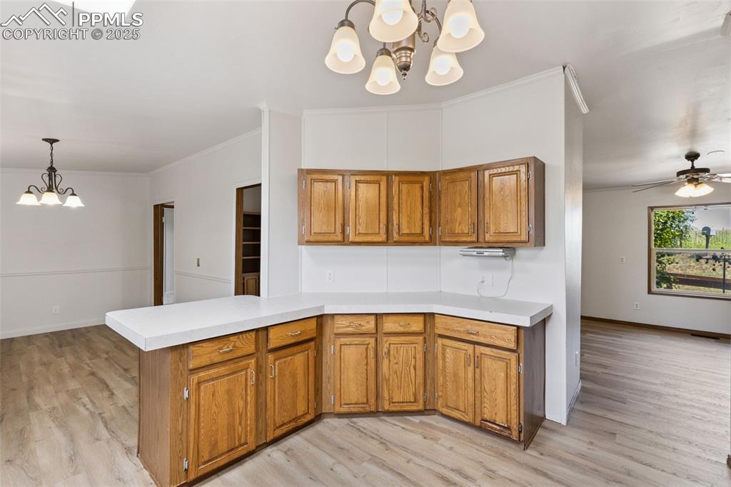 16175 Cathys Loop Peyton, CO 80831 - Photo 13 of 35 a spacious bathroom with a granite countertop sink and dishwasher with wooden floor