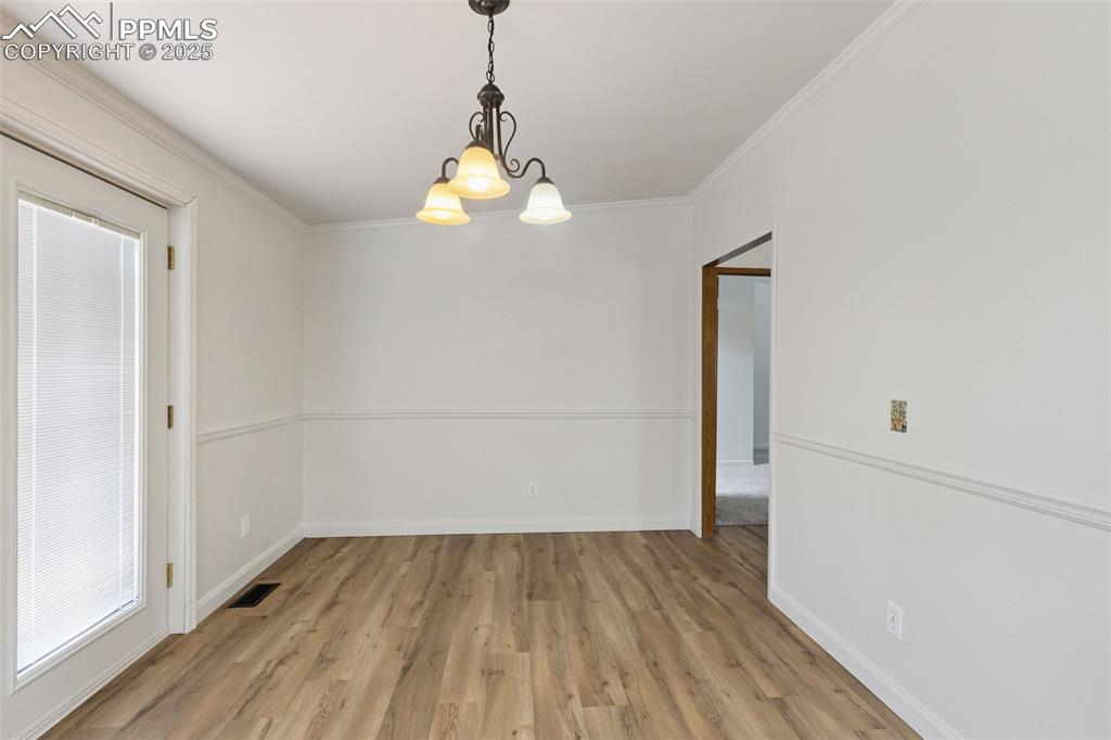 16175 Cathys Loop Peyton, CO 80831 - Photo 17 of 35 wooden floor in an empty room with a window