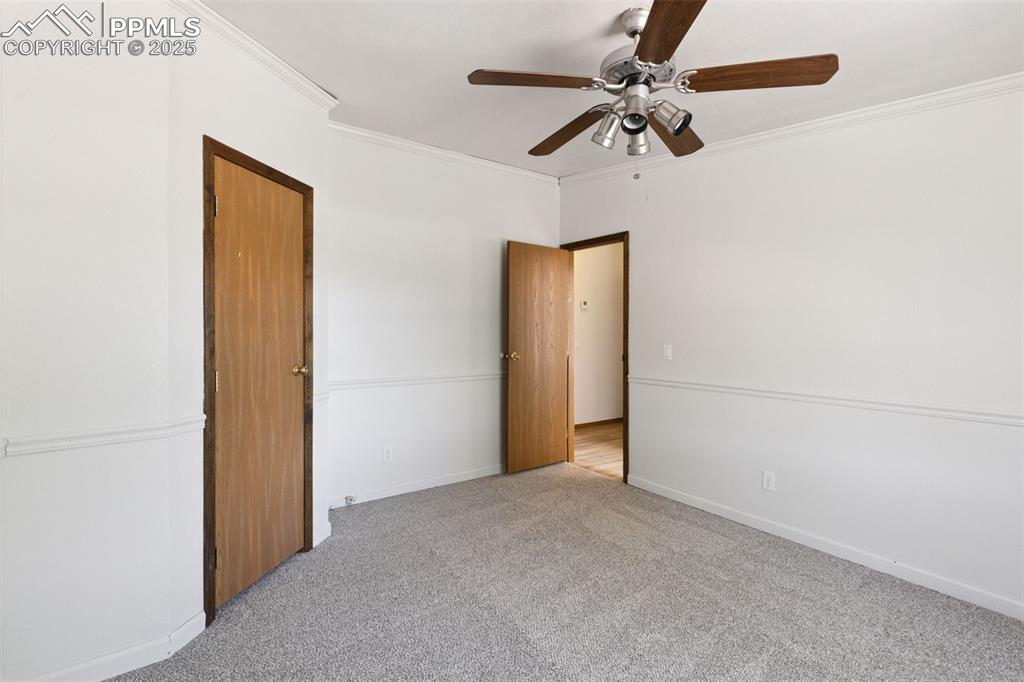 16175 Cathys Loop Peyton, CO 80831 - Photo 20 of 35 a view of a livingroom with a ceiling fan and a chandelier fan
