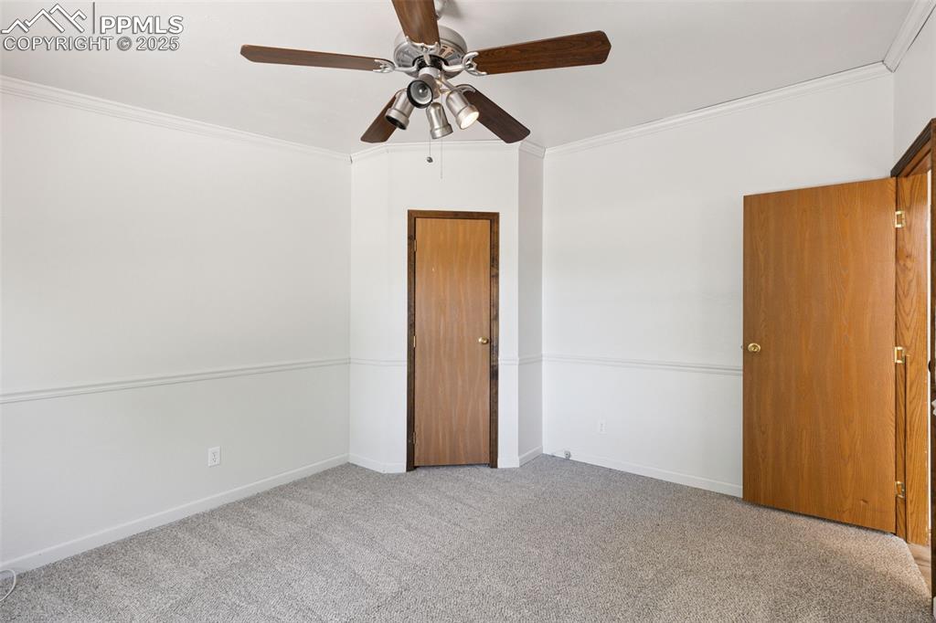 16175 Cathys Loop Peyton, CO 80831 - Photo 21 of 35 an empty room with a ceiling fan and a window