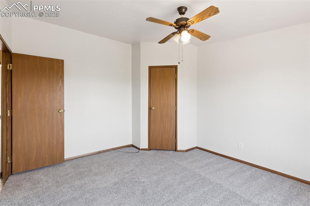 16175 Cathys Loop Peyton, CO 80831 - Photo 29 of 35 an empty room with a ceiling fan and a window