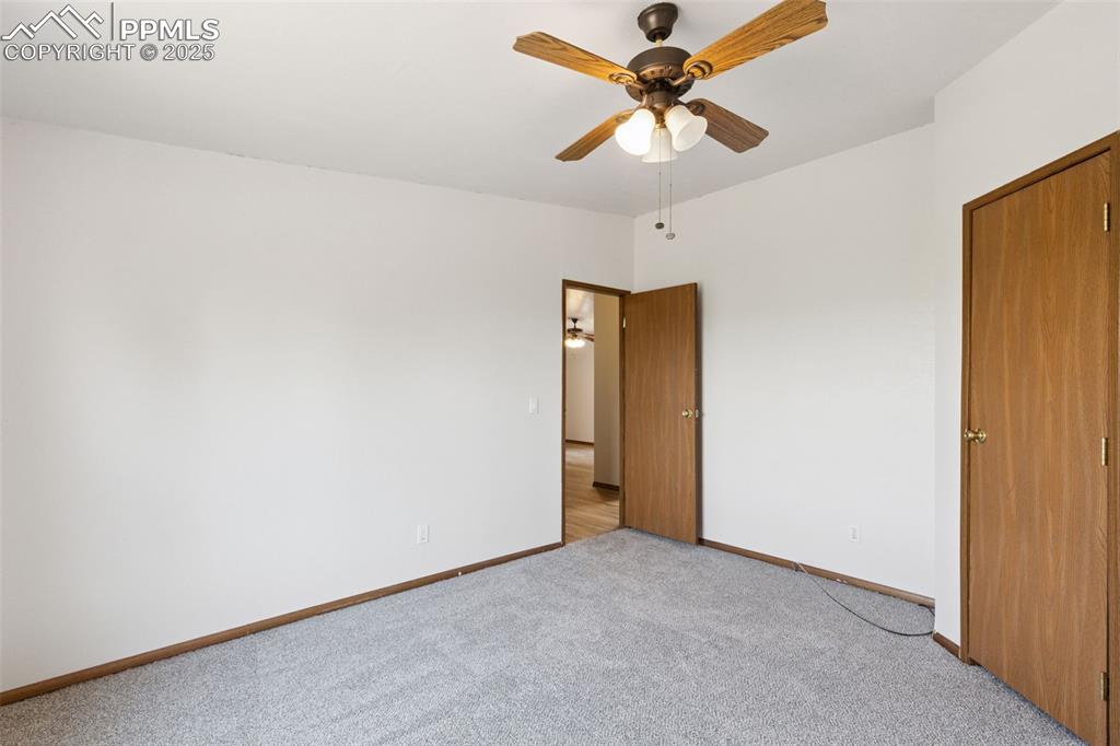 16175 Cathys Loop Peyton, CO 80831 - Photo 30 of 35 an empty room with a ceiling fan and a window