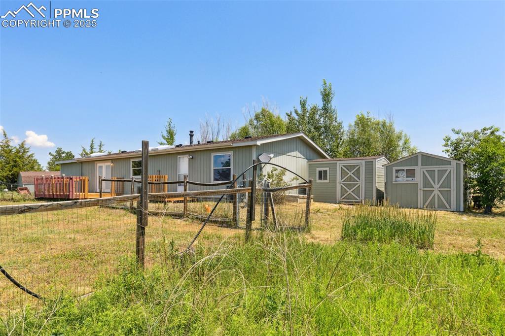 16175 Cathys Loop Peyton, CO 80831 - Photo 32 of 35 a house with swimming pool in front of it
