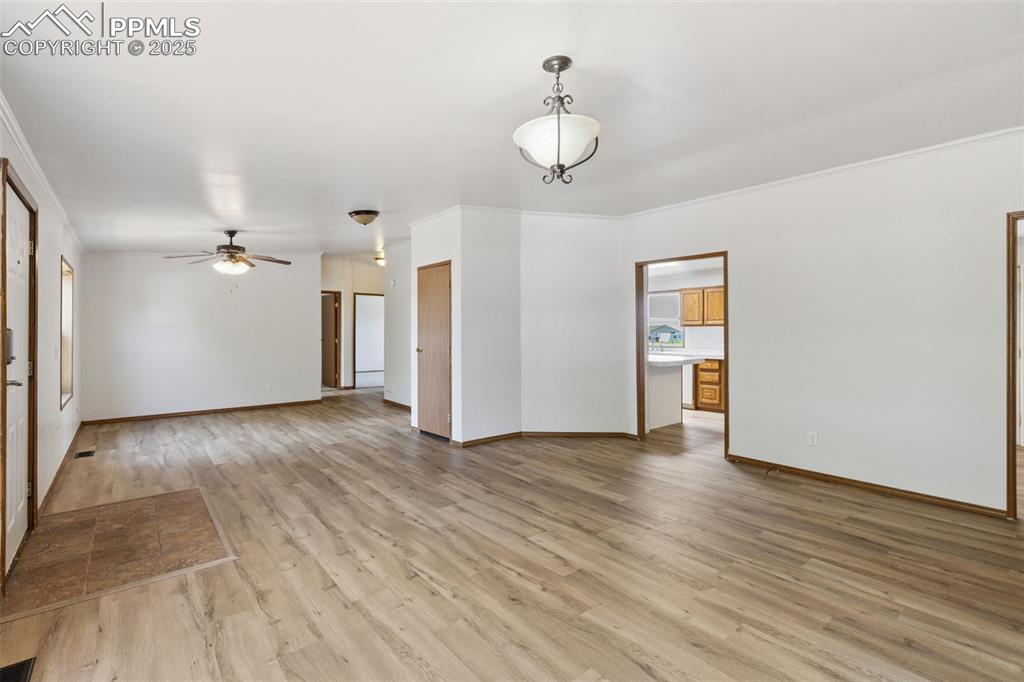 16175 Cathys Loop Peyton, CO 80831 - Photo 6 of 35 a view of a livingroom with wooden floor and ceiling fan