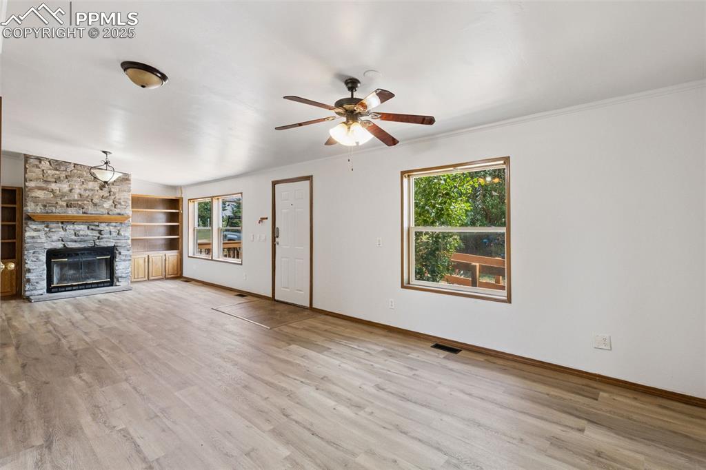 16175 Cathys Loop Peyton, CO 80831 - Photo 9 of 35 a view of an empty room with a window and fireplace