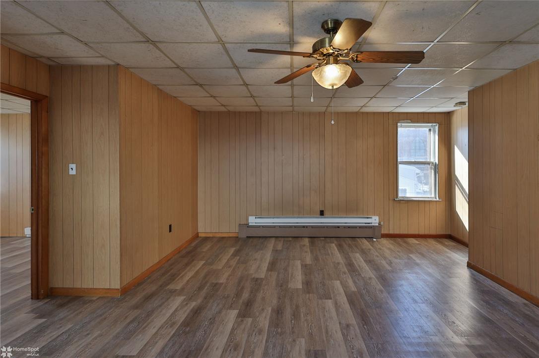 115 East Ruddle Street Coaldale, PA 18218 - Photo 16 of 57 Classic wood paneling and durable wood-look flooring establish a warm foundation in this versatile room.